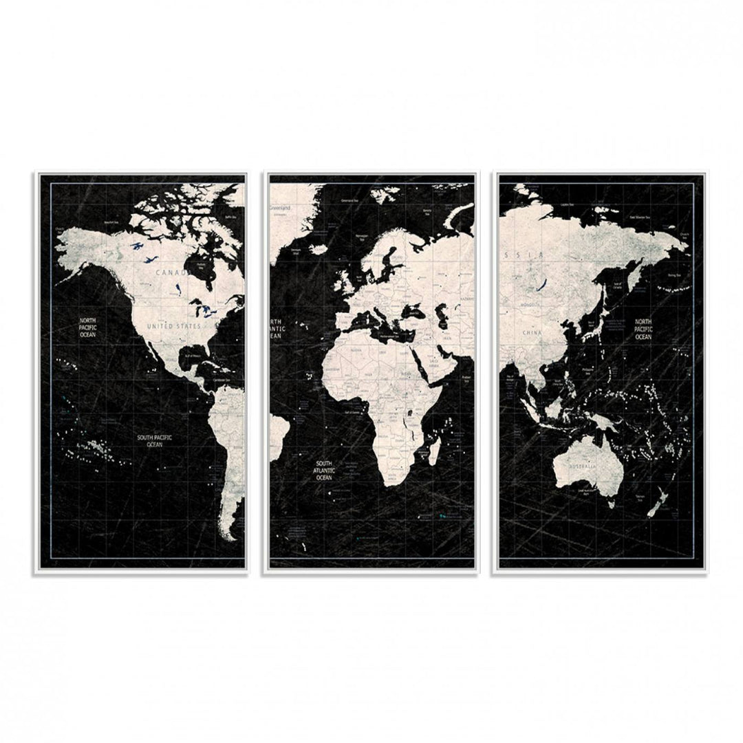 A bold global style framed black and white world map canvas print, presented in three panels, perfect for modern home or office decor.