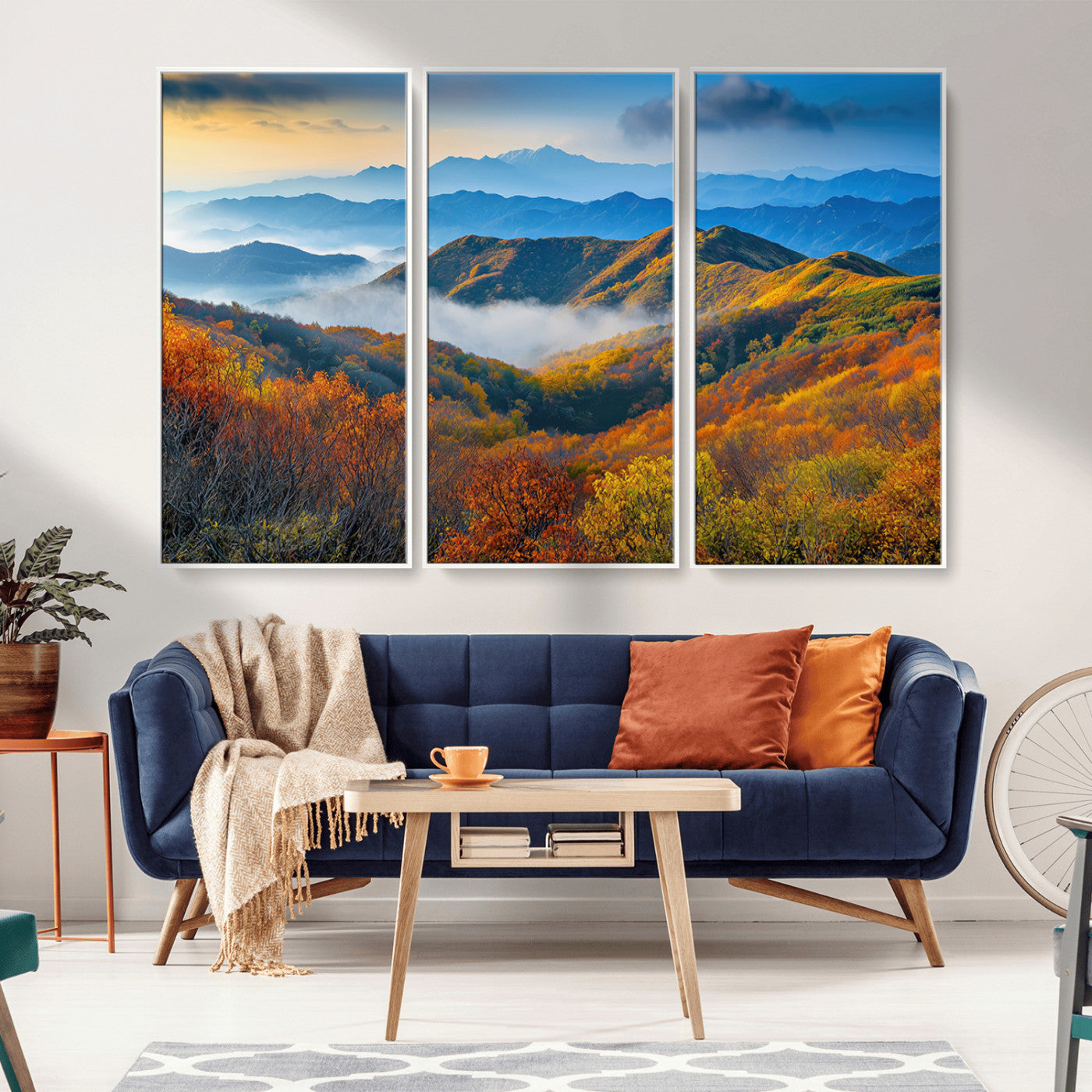 Vibrant canvas of autumn mountains with colorful trees, layered blue ridges, and soft morning fog, ideal for bright nature-themed decor.
