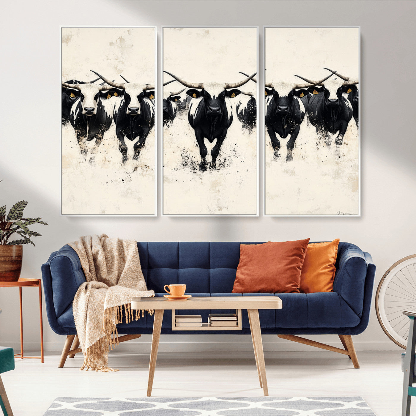 Canvas artwork of black and white Texas longhorns in a bold stampede over a minimalist background, ideal for rustic modern or Western-themed decor.