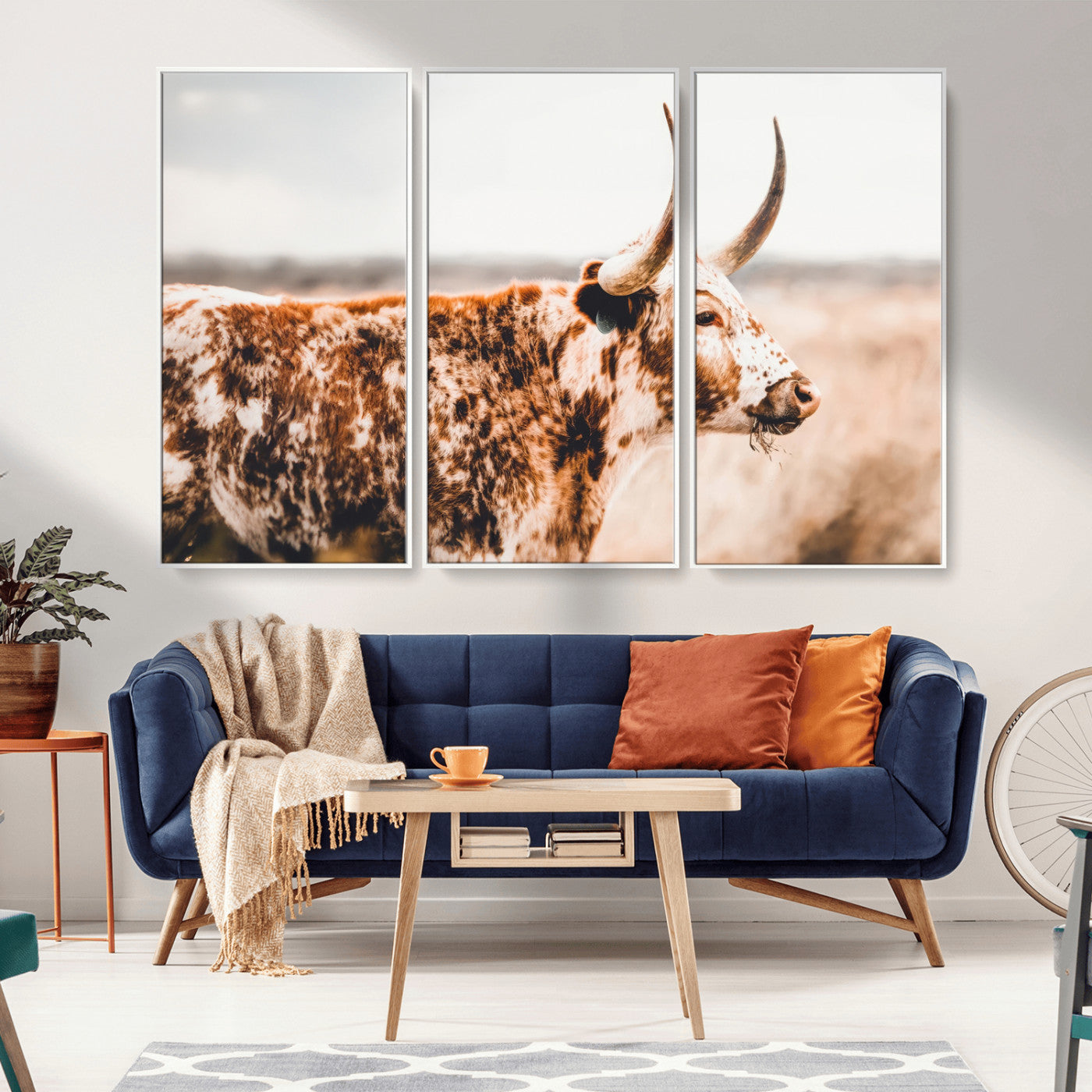 Speckled Texas longhorn with curved horns standing in a warm-toned prairie, perfect for rustic or country-style home decor.