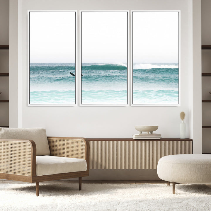 Minimalist photo of a lone surfer on calm aqua waves under bright sky, perfect for Scandinavian coastal or serene ocean-inspired home decor.