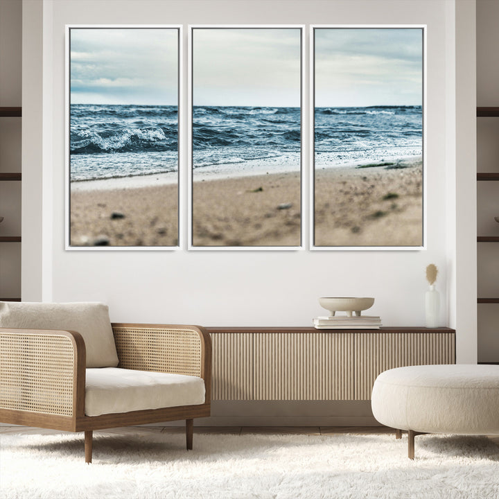 A moody ocean scene with gentle waves washing onto a sandy beach under a cloudy sky, creating a peaceful and coastal atmosphere.