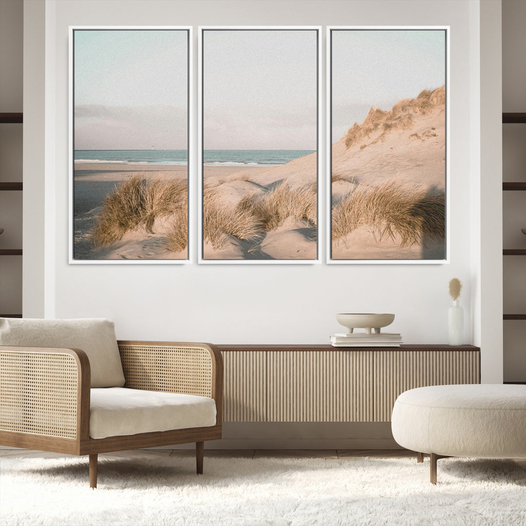 Soft pastel-toned beach scene with sand dunes, windswept grasses, and a calm ocean horizon, creating a serene coastal atmosphere.