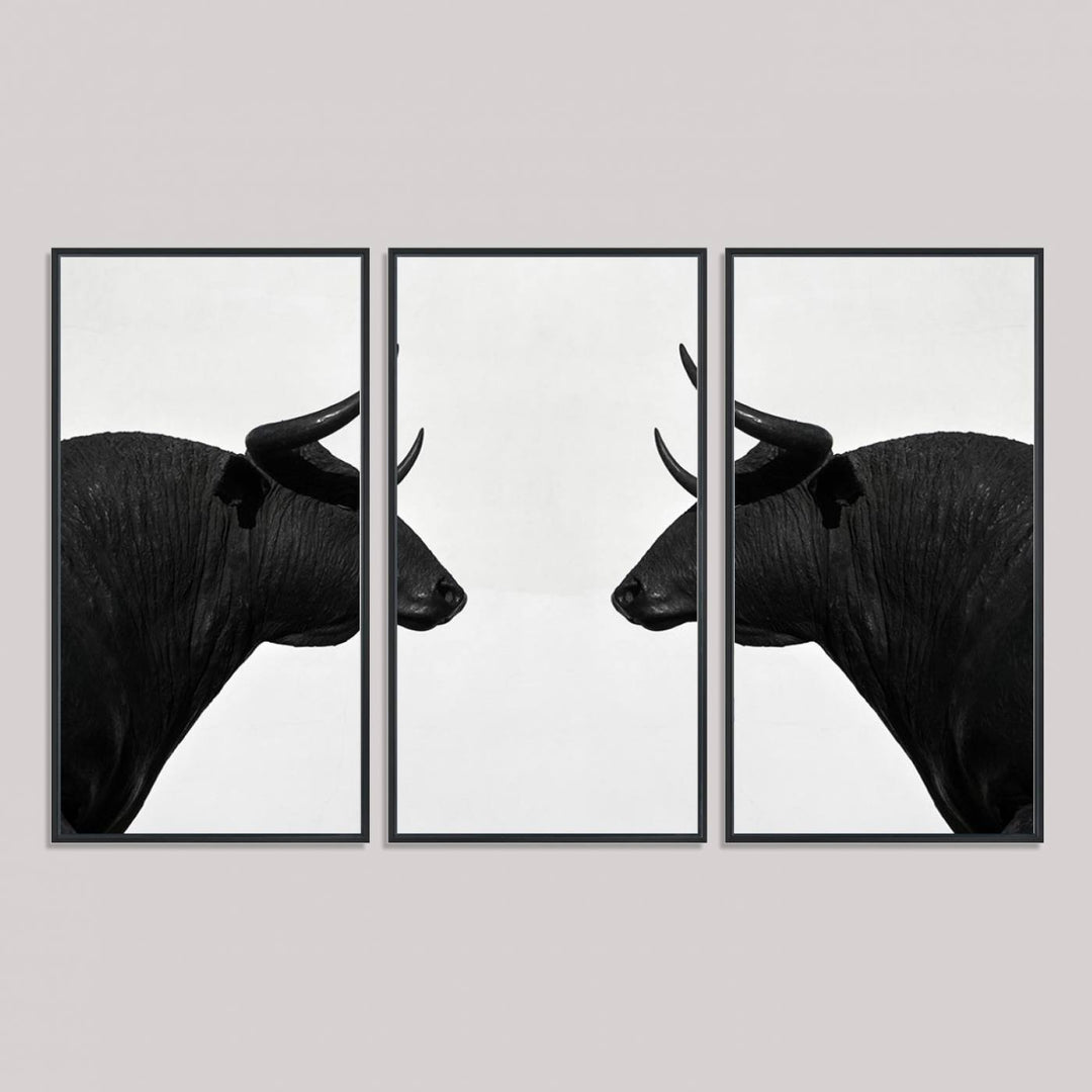 A framed canvas print featuring two black bull silhouettes, perfect for modern rustic decor.