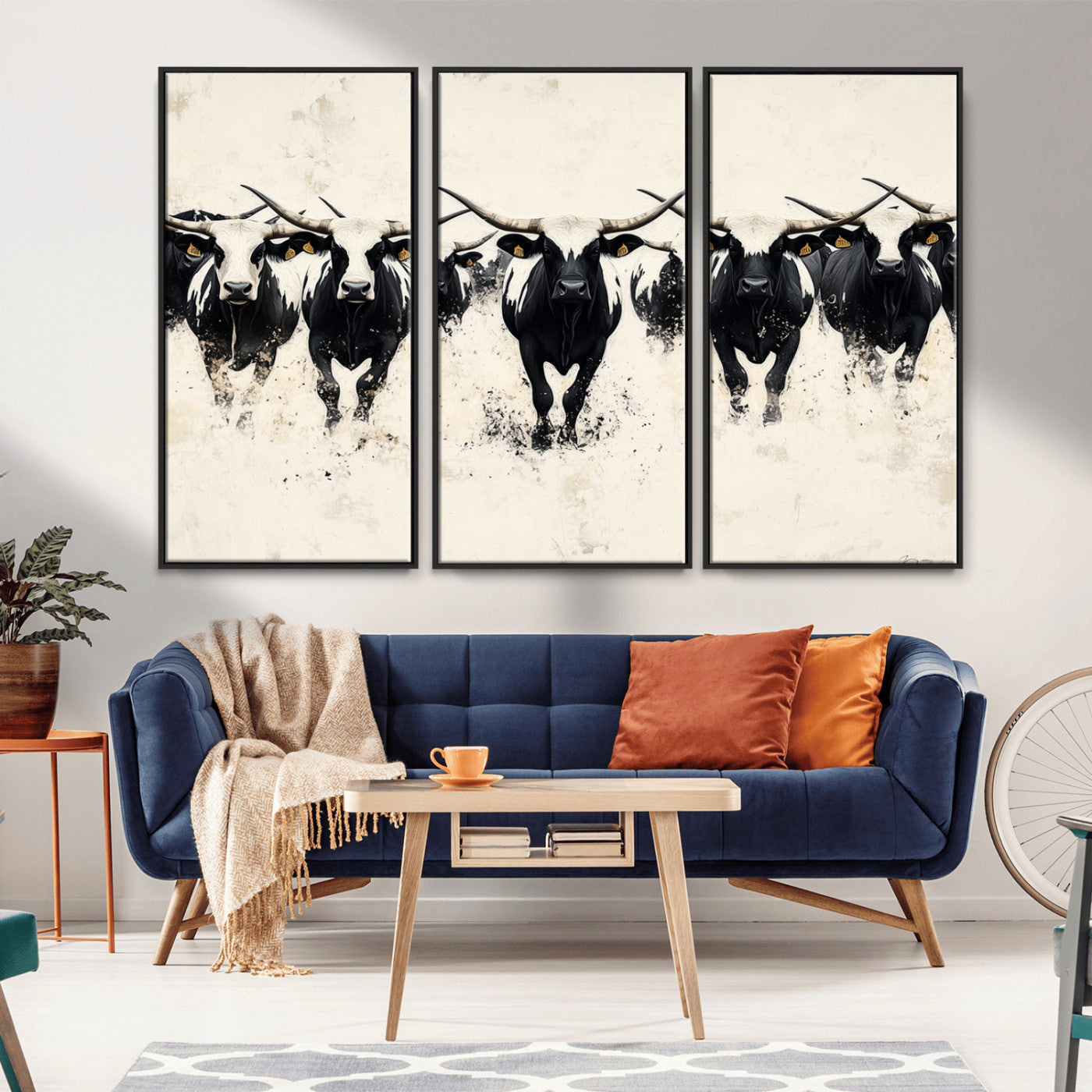 Canvas artwork of black and white Texas longhorns in a bold stampede over a minimalist background, ideal for rustic modern or Western-themed decor.