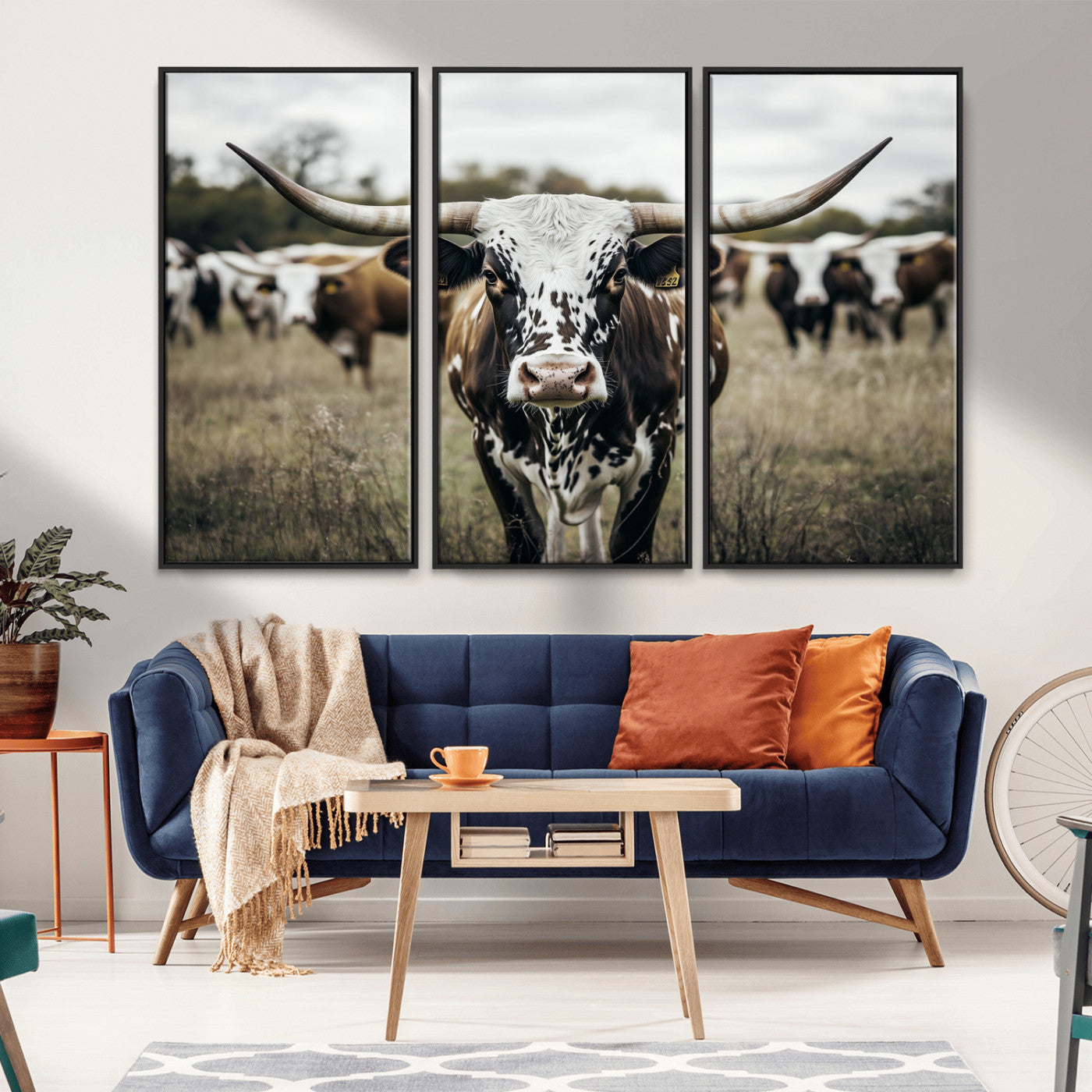 Canvas of a speckled Texas longhorn standing boldly in a field with a herd behind, perfect for rustic western or farmhouse wall decor.