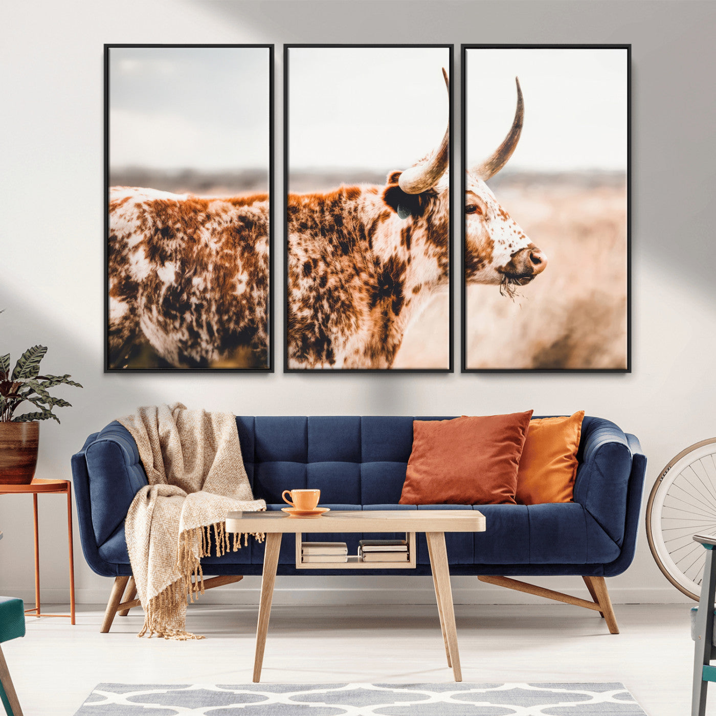 Speckled Texas longhorn with curved horns standing in a warm-toned prairie, perfect for rustic or country-style home decor.