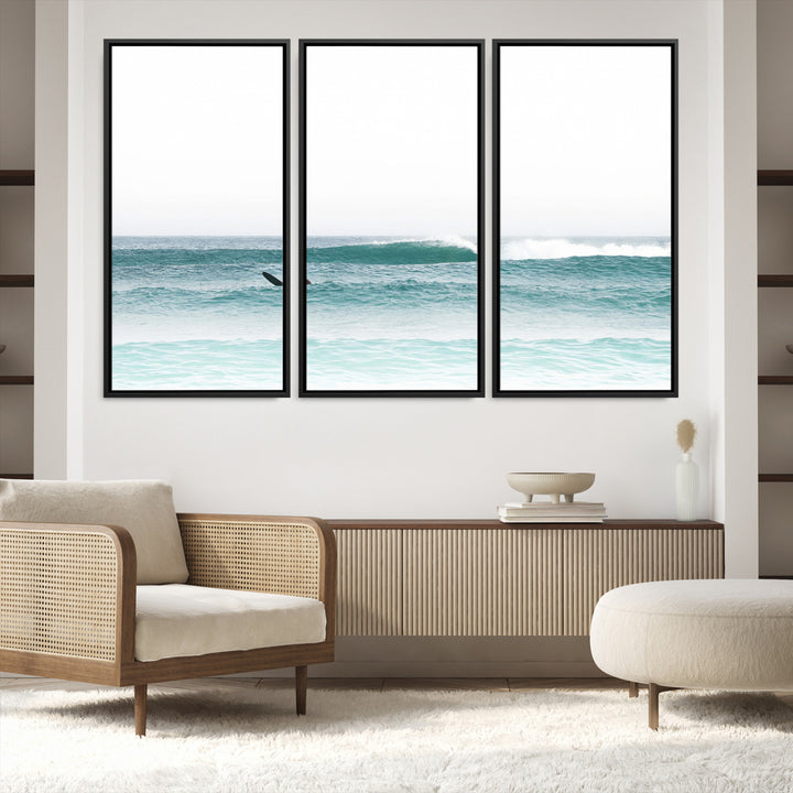 Minimalist photo of a lone surfer on calm aqua waves under bright sky, perfect for Scandinavian coastal or serene ocean-inspired home decor.
