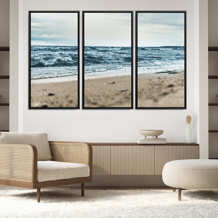 A moody ocean scene with gentle waves washing onto a sandy beach under a cloudy sky, creating a peaceful and coastal atmosphere.