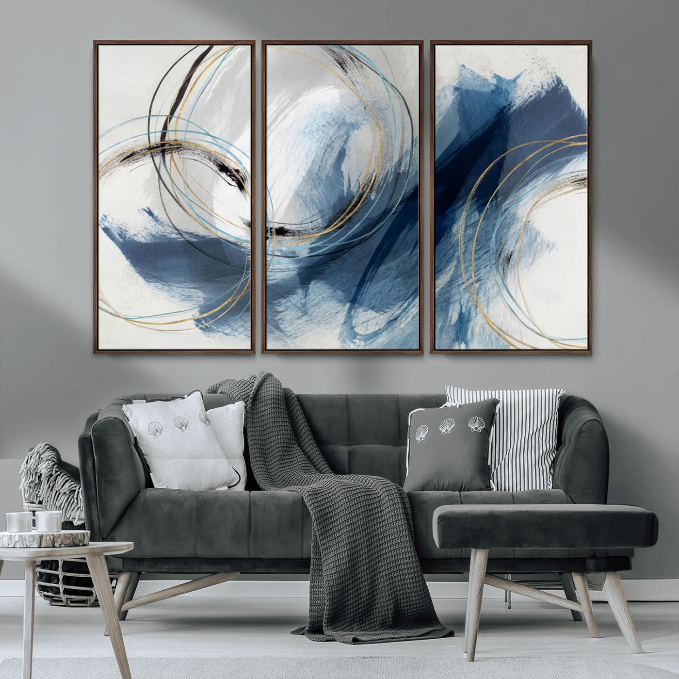 Abstract wall art featuring dynamic brush strokes in shades of blue and gray, overlaid with delicate circular line patterns in gold, black, and light blue on a white background.