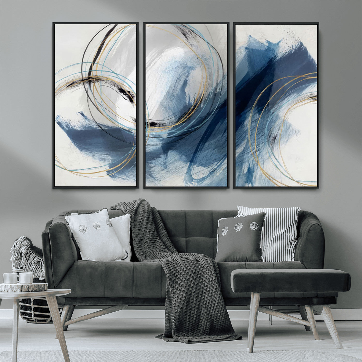 Abstract wall art featuring dynamic brush strokes in shades of blue and gray, overlaid with delicate circular line patterns in gold, black, and light blue on a white background.