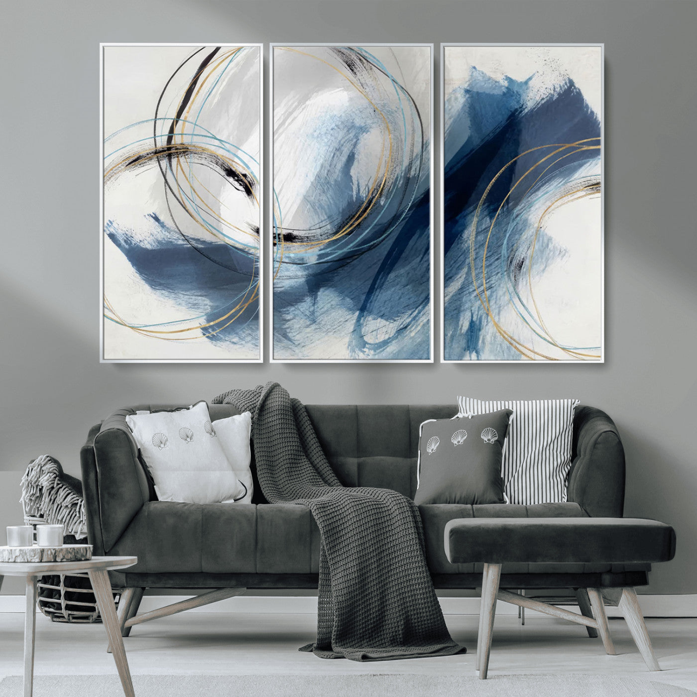Abstract wall art featuring dynamic brush strokes in shades of blue and gray, overlaid with delicate circular line patterns in gold, black, and light blue on a white background.