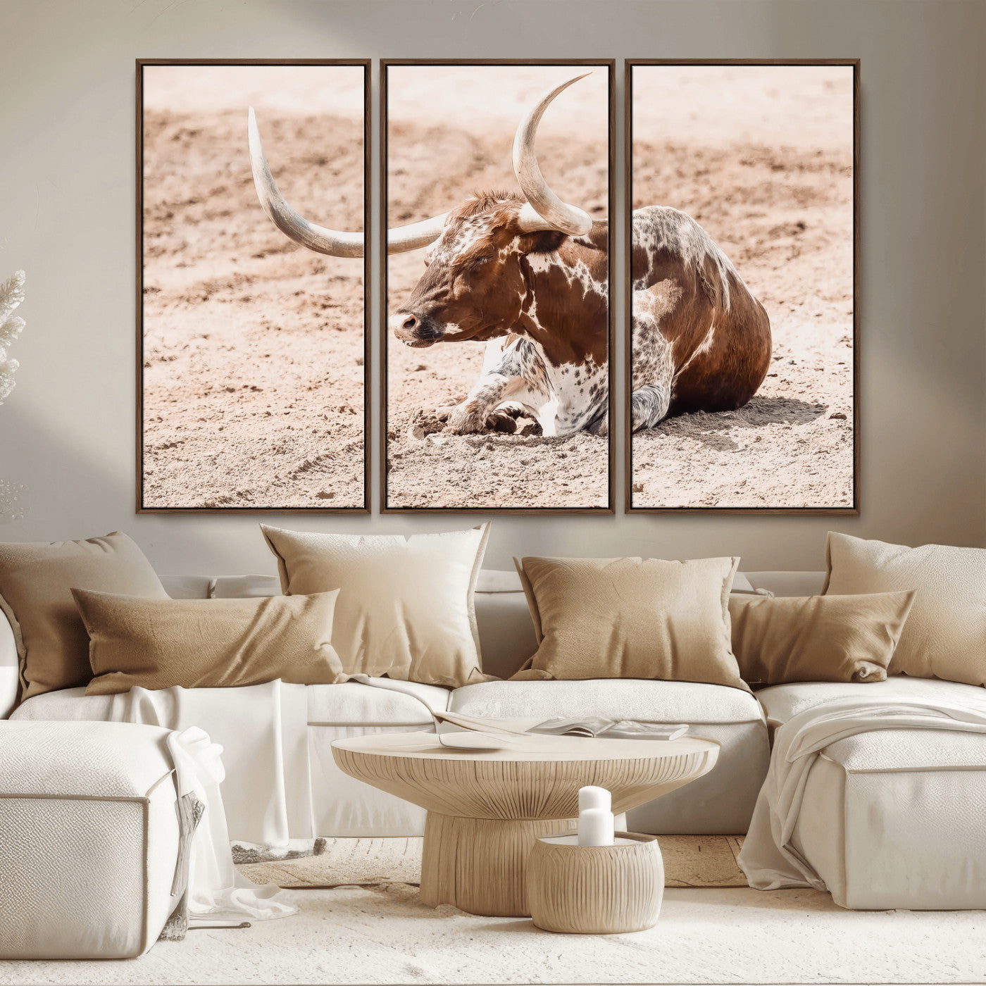 Texas Longhorn bull resting on dusty ground with warm tones, ideal for rustic western or farmhouse-themed wall decor.