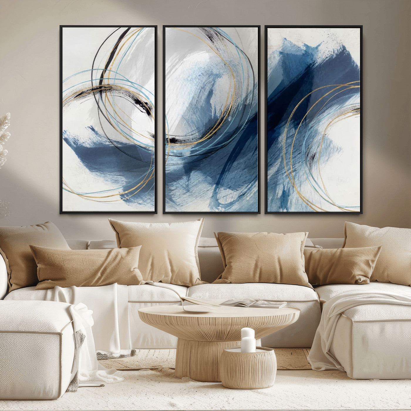 Abstract wall art featuring dynamic brush strokes in shades of blue and gray, overlaid with delicate circular line patterns in gold, black, and light blue on a white background.