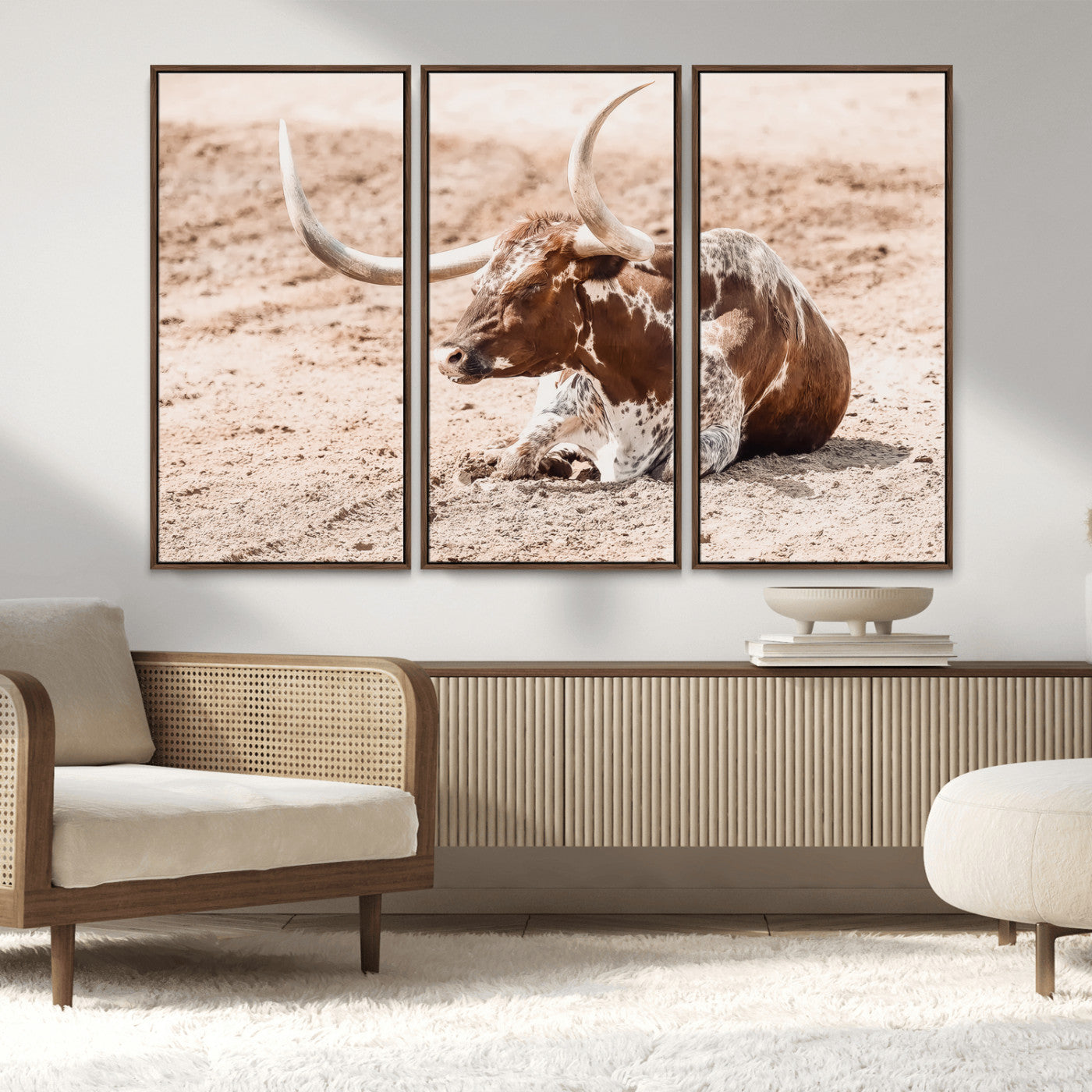 Texas Longhorn bull resting on dusty ground with warm tones, ideal for rustic western or farmhouse-themed wall decor.