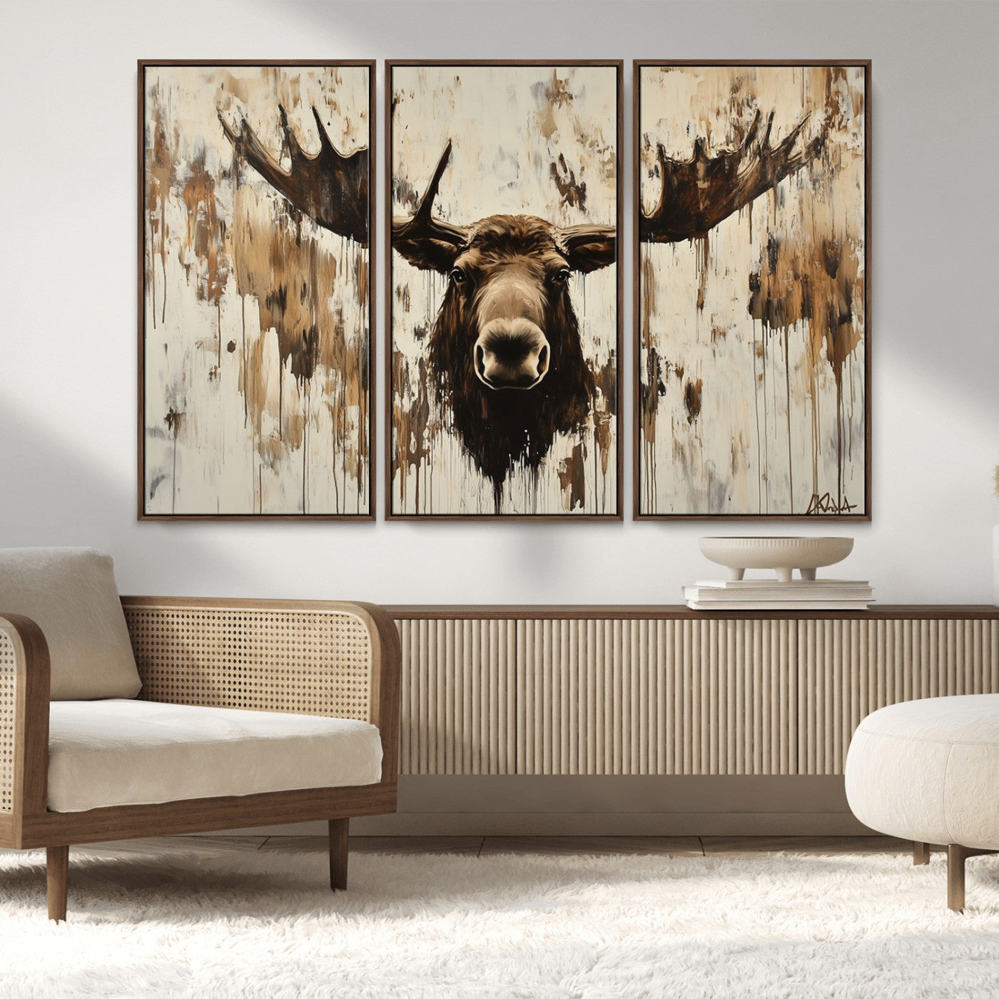 Expressive painting of a moose head with wide antlers in dark brown and beige tones, featuring paint drips and splatters on a light textured background, creating a striking rustic wall art canvas.