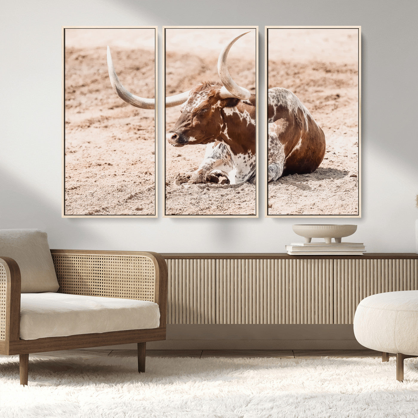 Texas Longhorn bull resting on dusty ground with warm tones, ideal for rustic western or farmhouse-themed wall decor.
