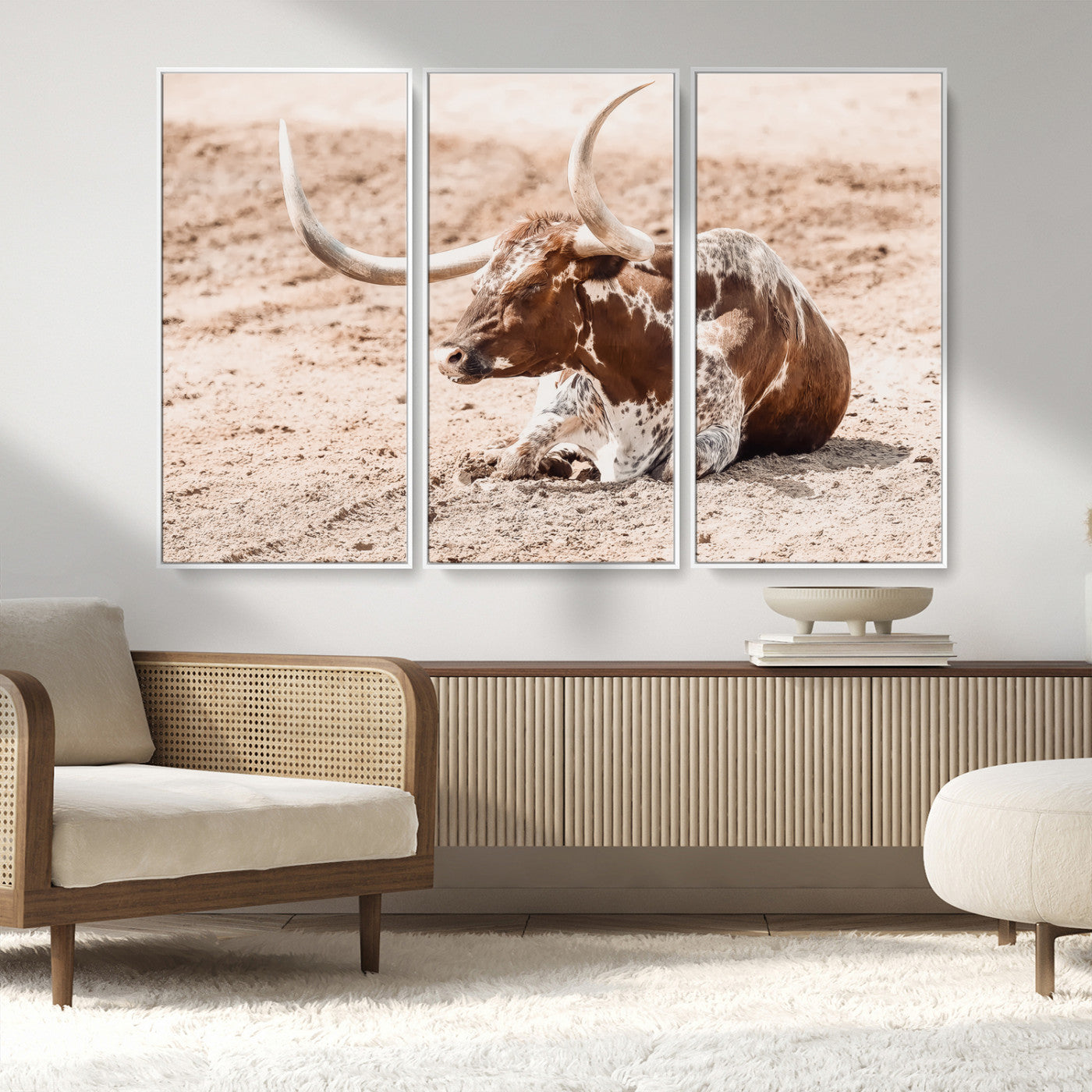 Texas Longhorn bull resting on dusty ground with warm tones, ideal for rustic western or farmhouse-themed wall decor.