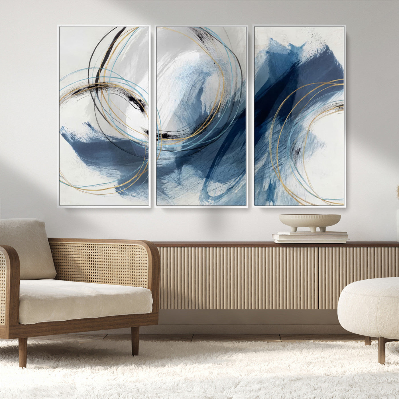 Abstract wall art featuring dynamic brush strokes in shades of blue and gray, overlaid with delicate circular line patterns in gold, black, and light blue on a white background.