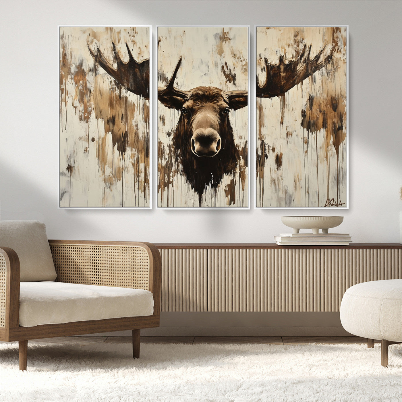 Expressive painting of a moose head with wide antlers in dark brown and beige tones, featuring paint drips and splatters on a light textured background, creating a striking rustic wall art canvas.