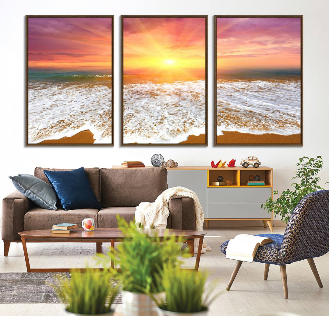 Golden Beach Sunrise 3-panel canvas art of ocean waves, hung on a wooden wall.