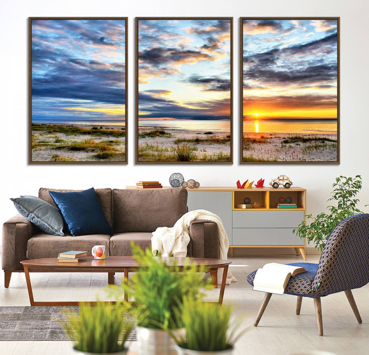 The Sunset On The Ocean canvas wall art features a beautiful beach sunset with grass and clouds.