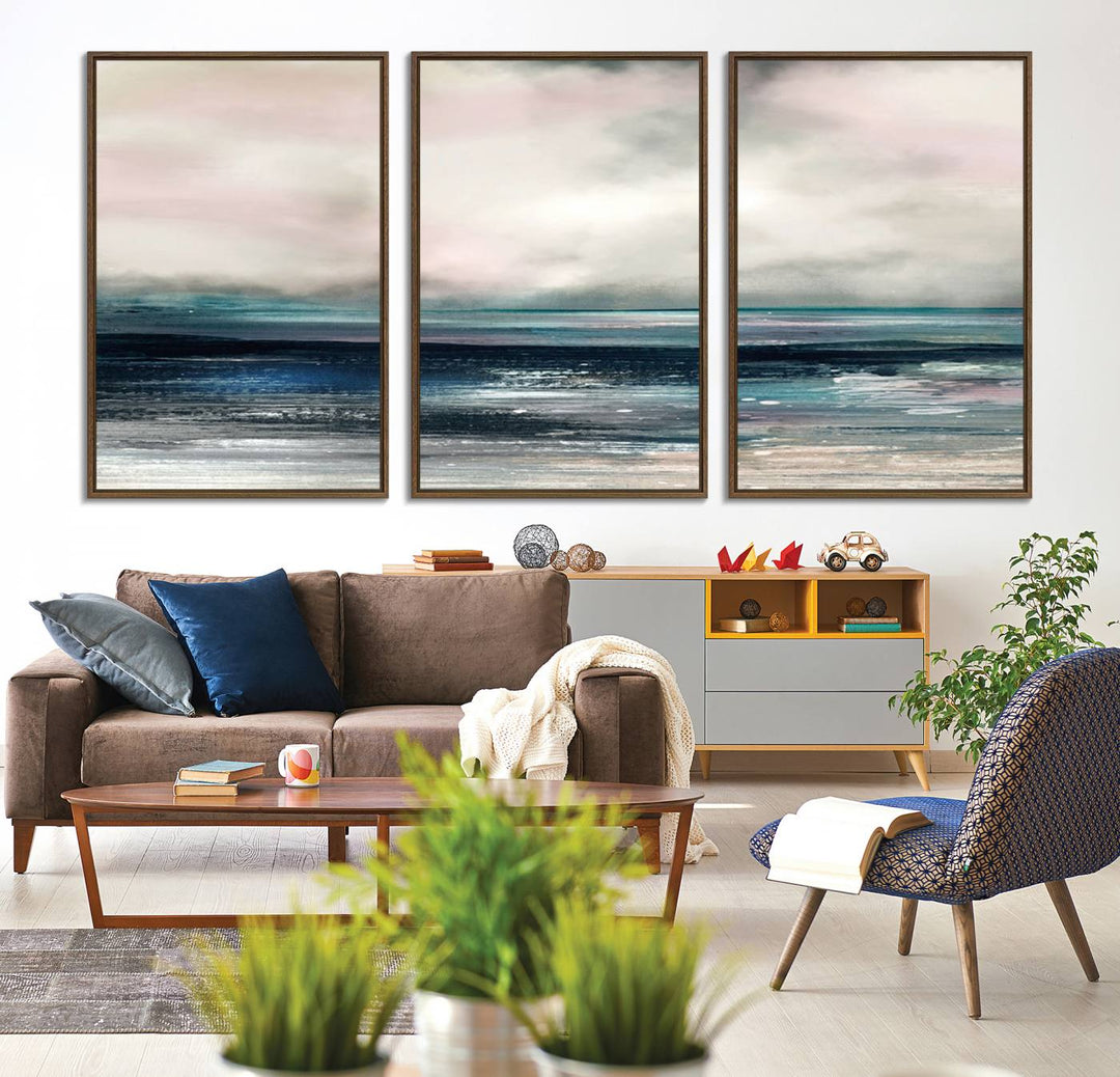 A contemporary abstract wall art canvas print in pastel pink, teal, and gray tones hangs on the wall.