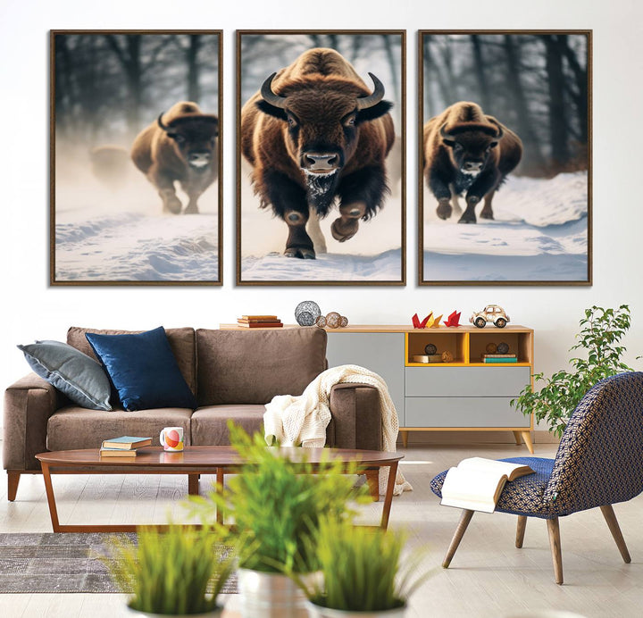 Wall art titled Cow Bighorn shows three bison running through snow in a forest.