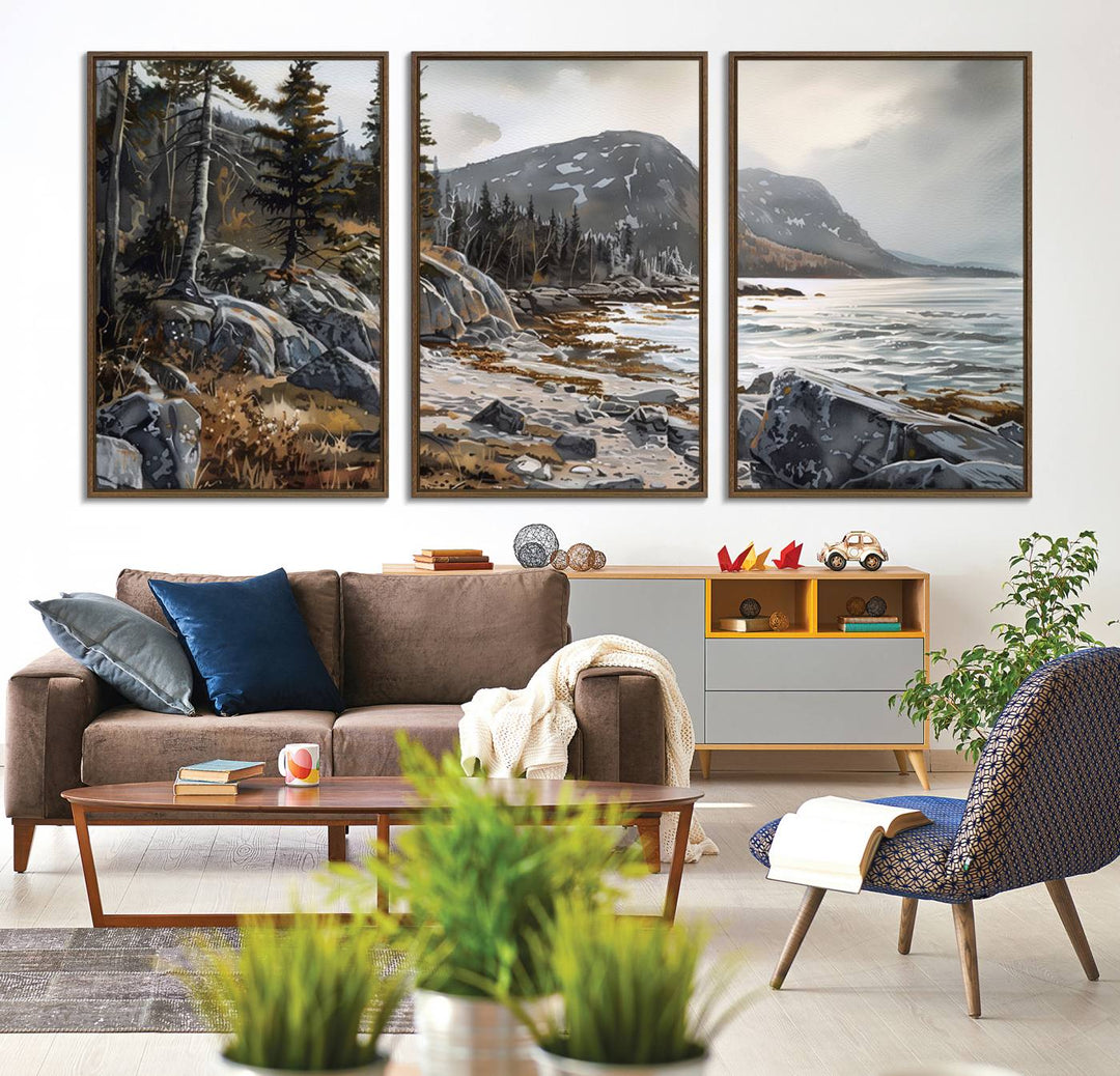 Framed wall art depicting Acadia National Parks rocky coast, trees, mountains, and sunlight over the sea; ready to hang.