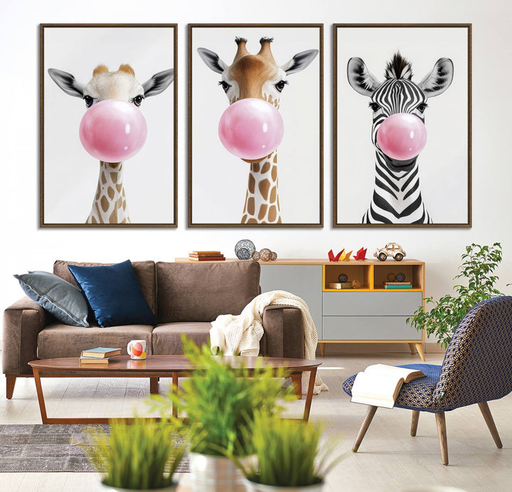 The Bubblegum Animals Canvas Wall Art, featuring a playful trio of giraffe and zebra portraits blowing pink bubblegum, brings charm and whimsy to your space. Ideal for nursery wall art or any fun area, this delightful decor piece is ready to hang and perfect for creating a playful atmosphere.