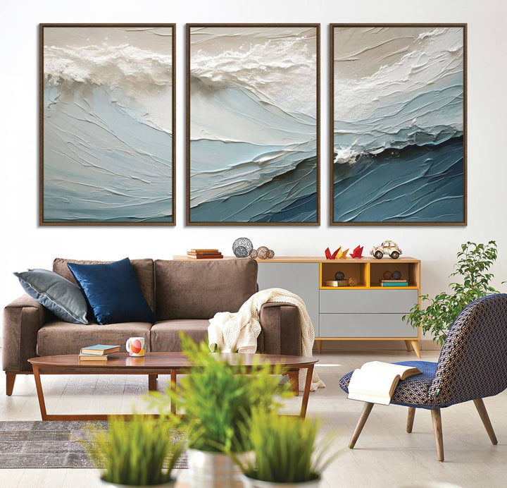 The Waves Abstract Wall Art Print is a large textured painting featuring ocean waves in beige and blue tones. This modern framed abstract canvas print captures the serene essence of seaside tranquility and serves as stunning ready-to-hang wall art, making it perfect as living room decor.