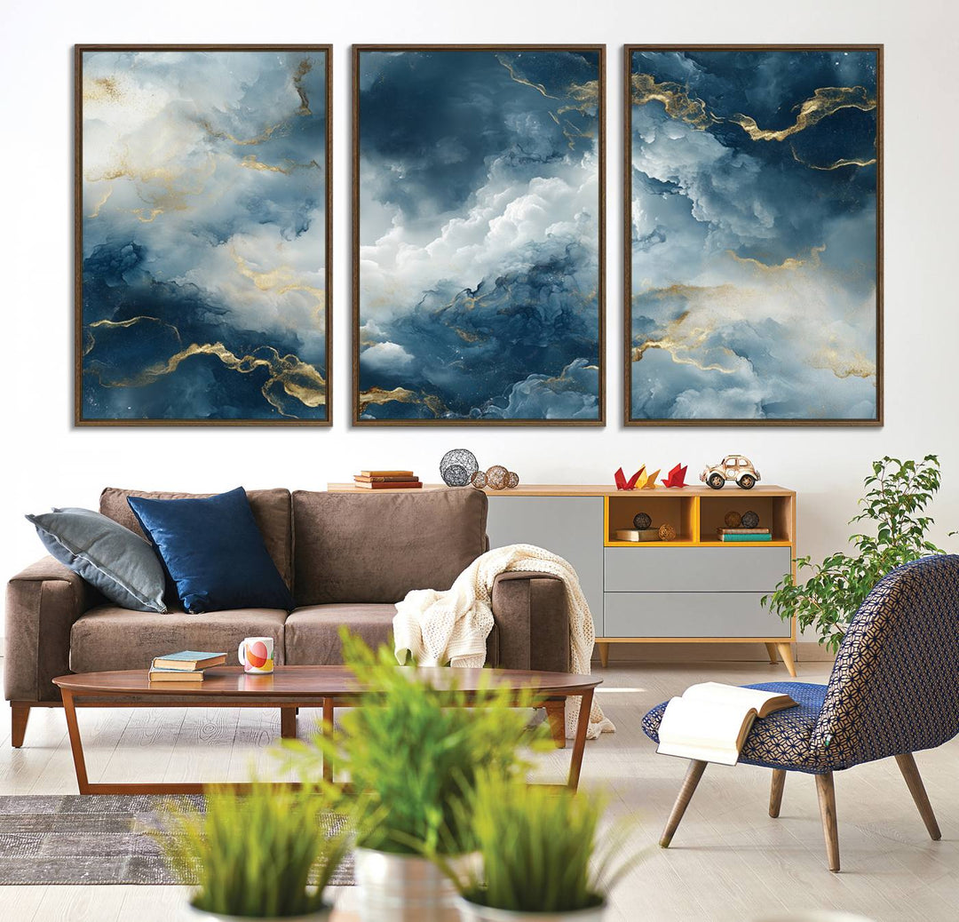 The "Large Abstract Print - Luxe Blue and Gold Abstract Canvas Wall Art" features a bold cloudscape design with swirling white patterns, ideal for modern home decor in living rooms or offices.