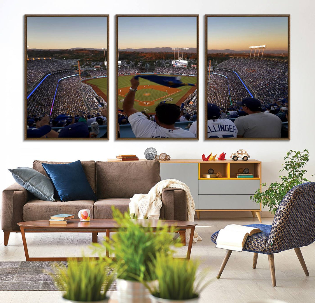 A triple canvas wall art captures the scene at Dodger Stadium, with fans cheering as the sun sets and a flag waving on the field.