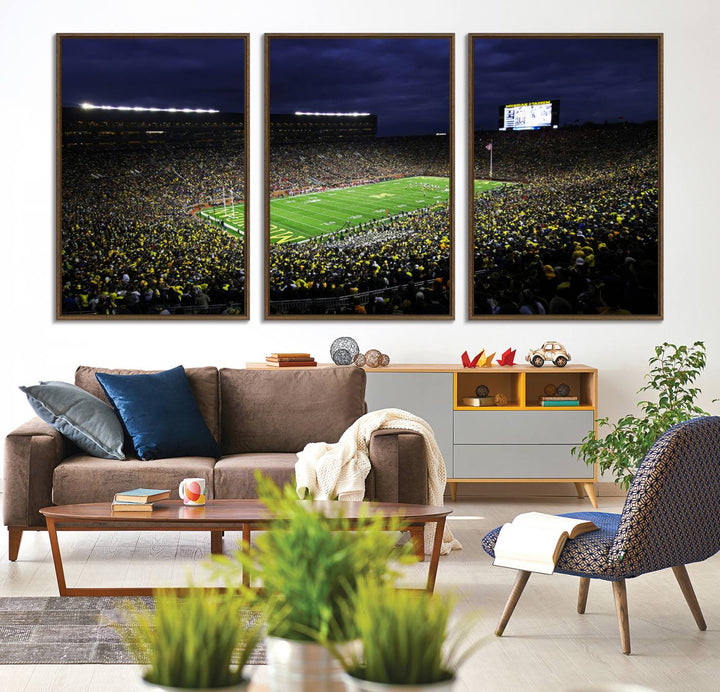 A painting of the packed Michigan Wolverines football stadium at night.