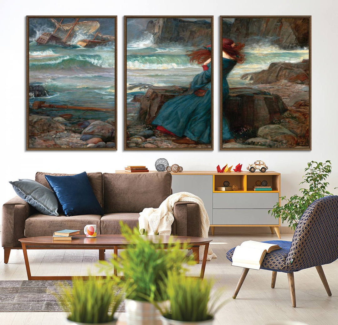 The Miranda by the Shore Wall Art Canvas Print depicts a woman in a blue dress standing by the sea, watching a shipwreck.