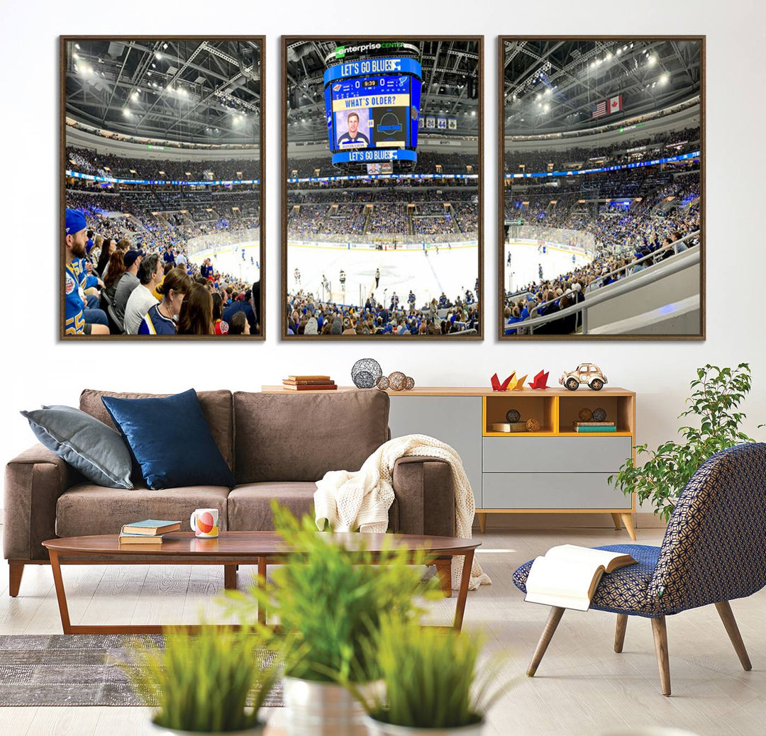 Wall art prints depicting the bustling scenes of the St. Louis Blues being cheered on by a full house at the Enterprise Center, beneath a large scoreboard.