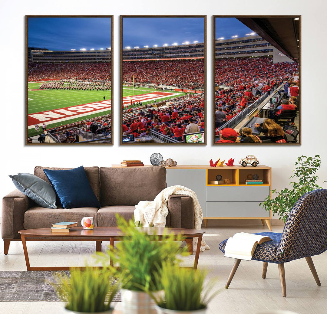 A vibrant wall art captures the essence of Madison Camp Randall Stadium, depicting a sea of fans in red and white during a Wisconsin Badgers football game under bright lights.