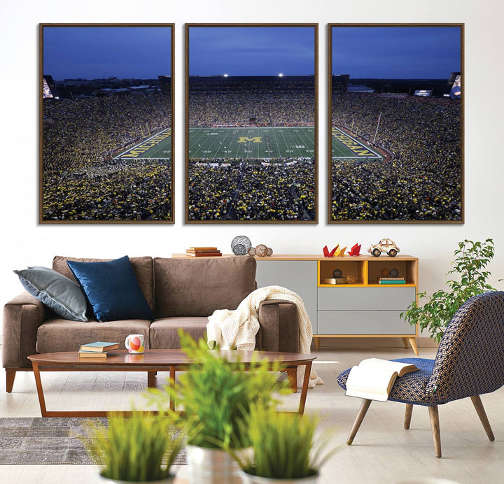 Wall art featuring an aerial shot of Michigan Stadium at dusk, showcasing the University of Michigan Wolverines M logo.