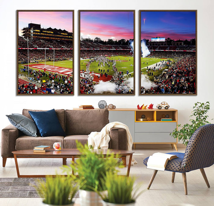 The wall art features a canvas print of the Stanford Cardinal football team, capturing players, fireworks, and smoke against the backdrop of a sunset at Stanford Stadium.