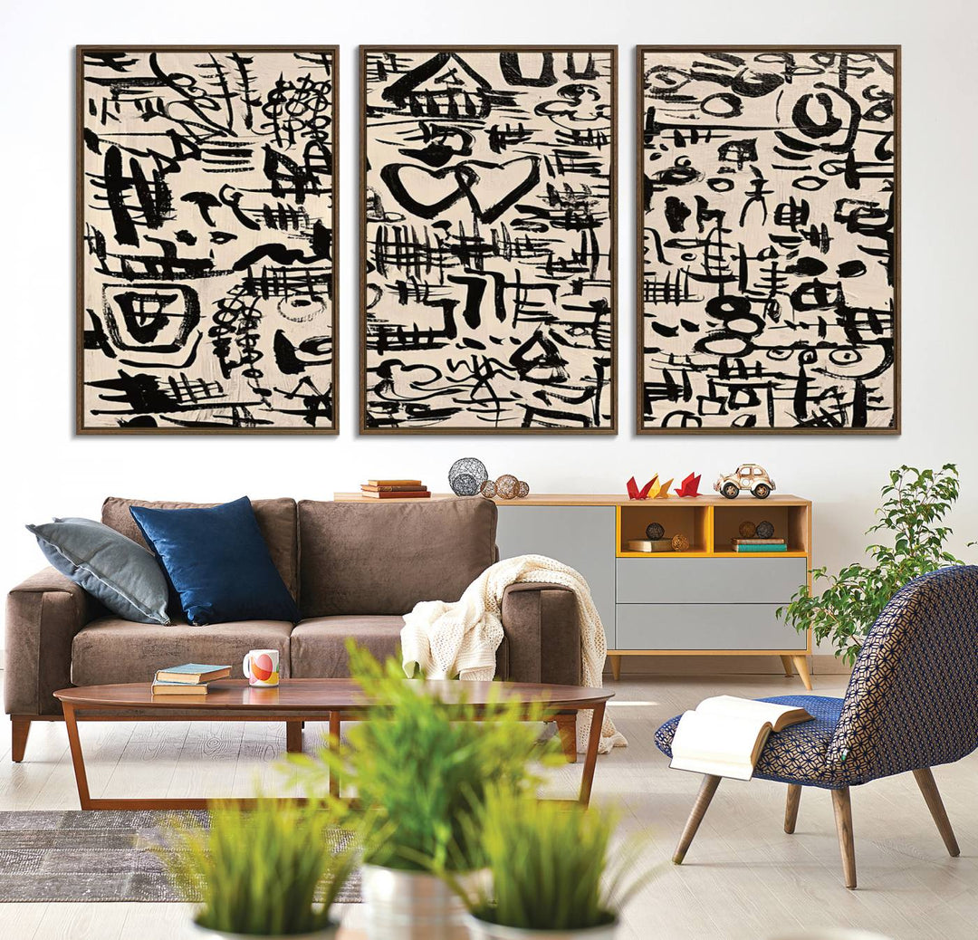 The Abstract Love and Chaos canvas is a museum-quality print featuring black symbols on a beige background, adorned with a heart and scribble design. It is framed to enhance its artistic appeal.