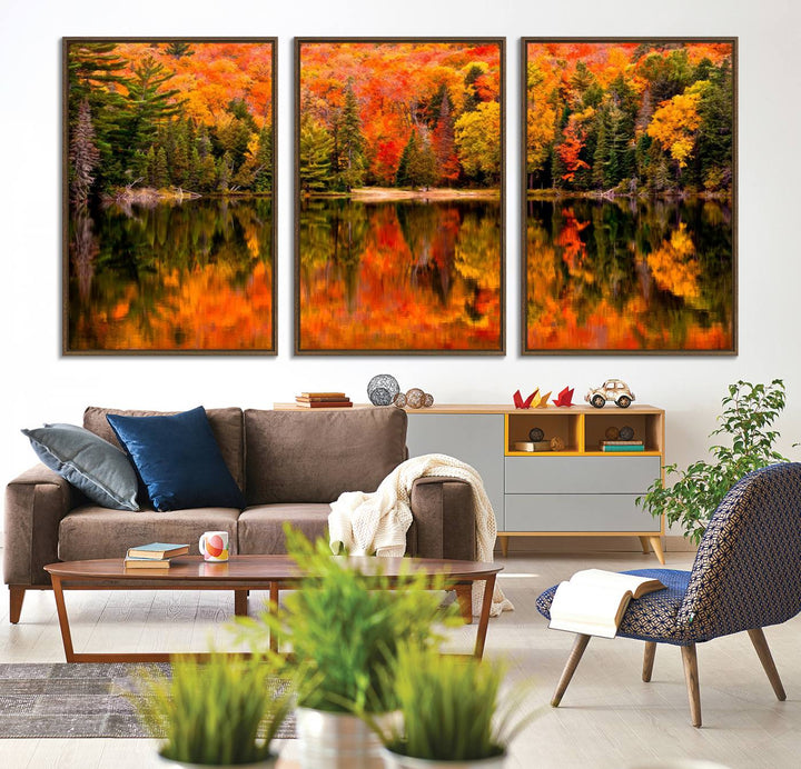 Autumn Forest Reflection Wall Art: a vibrant triptych canvas featuring fall foliage with red, orange, and yellow leaves over a calm lake.