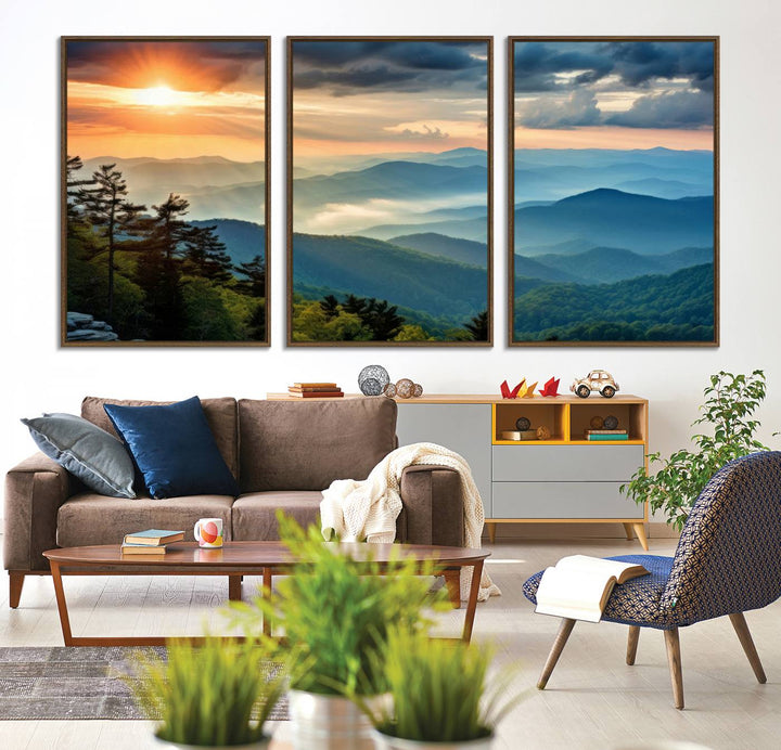 The wall art, titled Sunrise Over Mountain Range, is a canvas print that beautifully depicts layers of hills, scattered trees, and a partly cloudy sky.