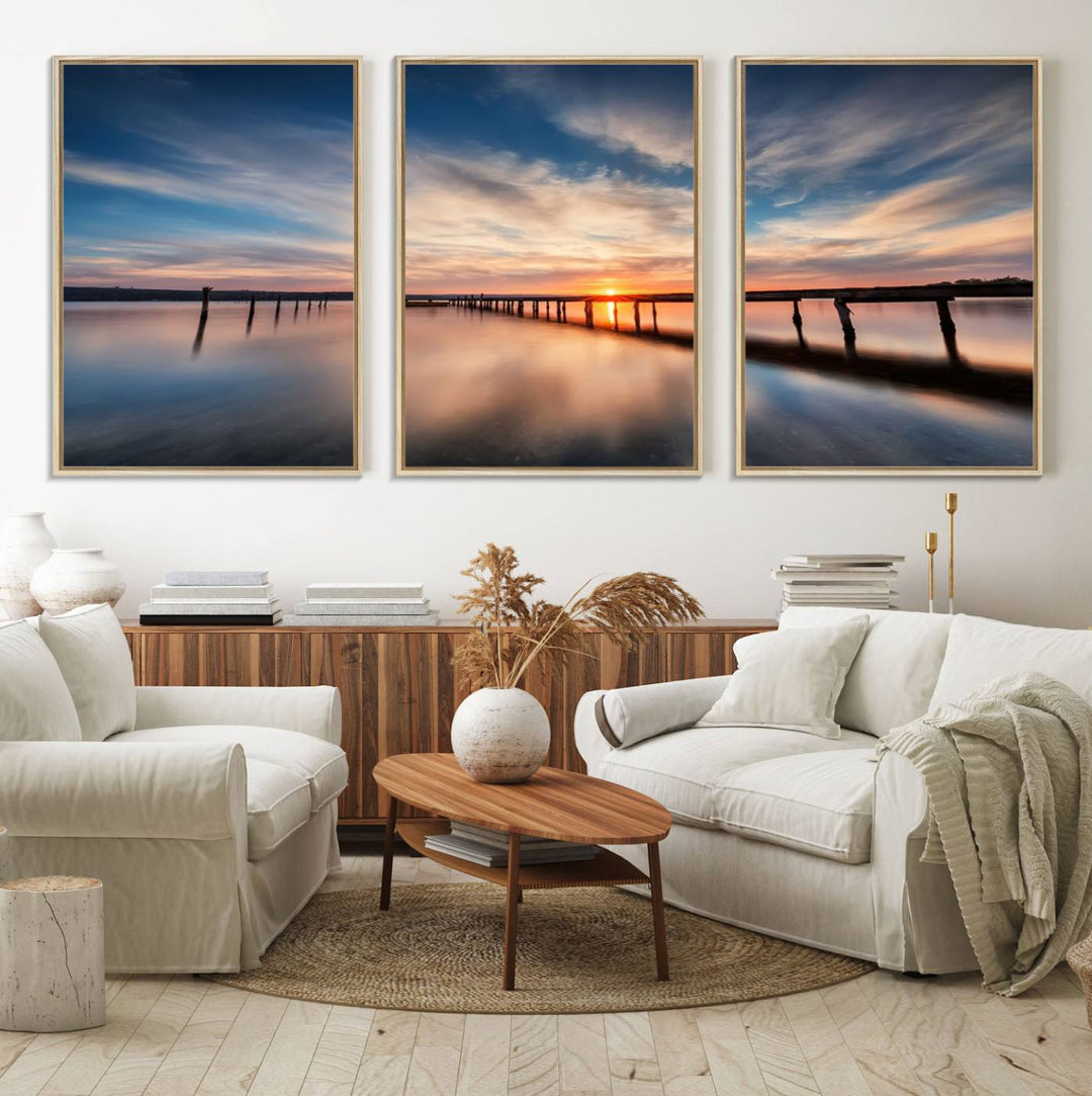 The Sunset Pier Canvas features a serene coastal landscape with vibrant hues under cloudy skies, ideal for modern decor.