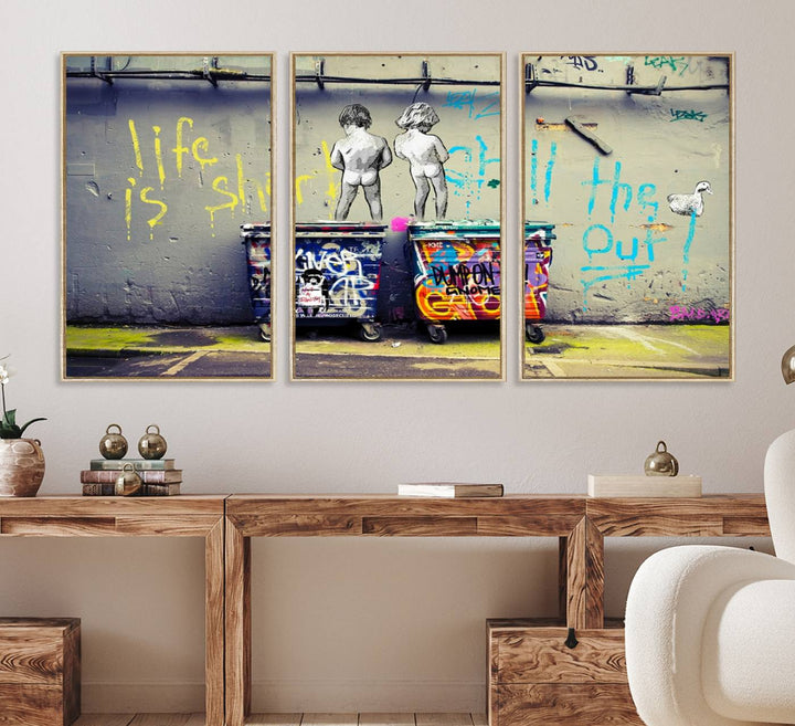 Banksys Life is Short graffiti, featuring kids and text, decorates the wall as a striking piece of framed canvas art.