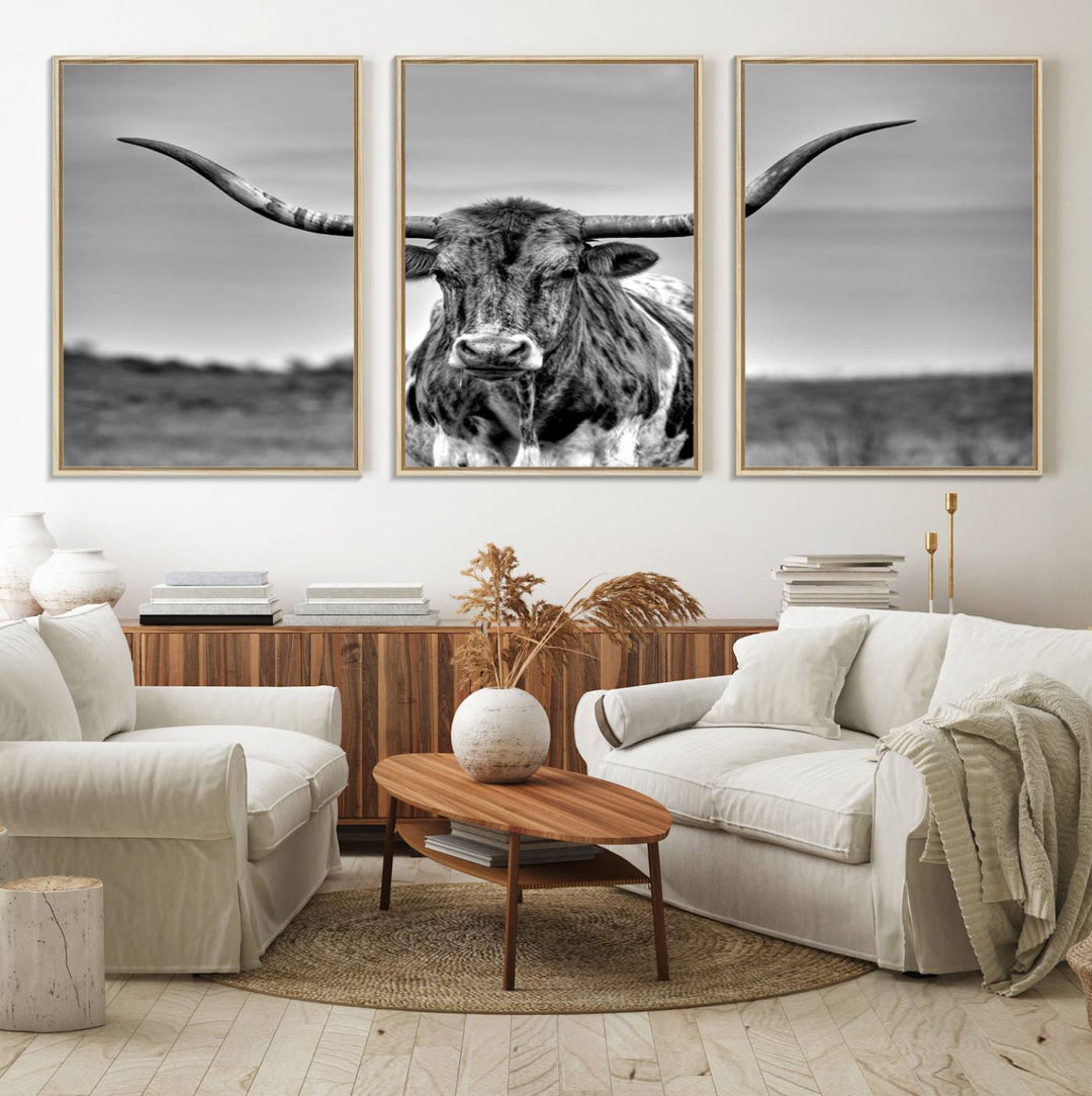 The Texas Longhorn Cow wall art, divided into three panels, is of gallery quality and displayed on a dark wall.