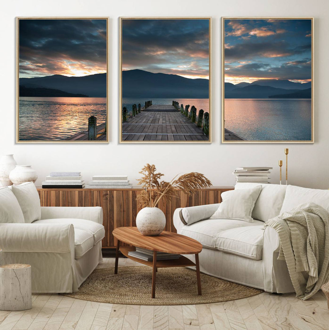 The Mountain Lake Wood Pier Canvas Wall Art depicts a serene lake and mountains, enhancing the beauty of any space.