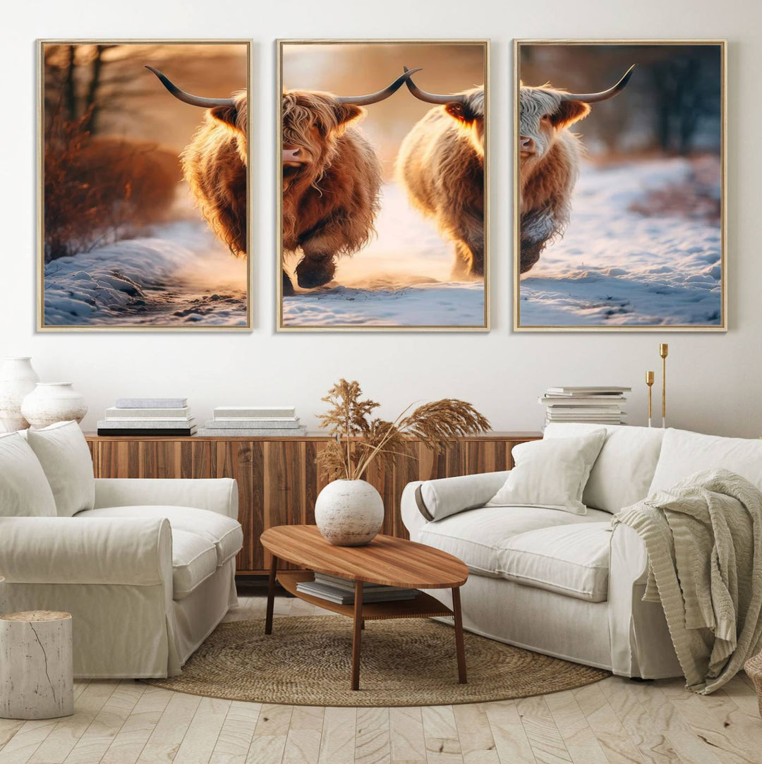 The wall art is a Scottish Highland Cow Horn canvas print featuring cows on a snowy path bathed in warm sunlight, serving as a rustic decor piece.