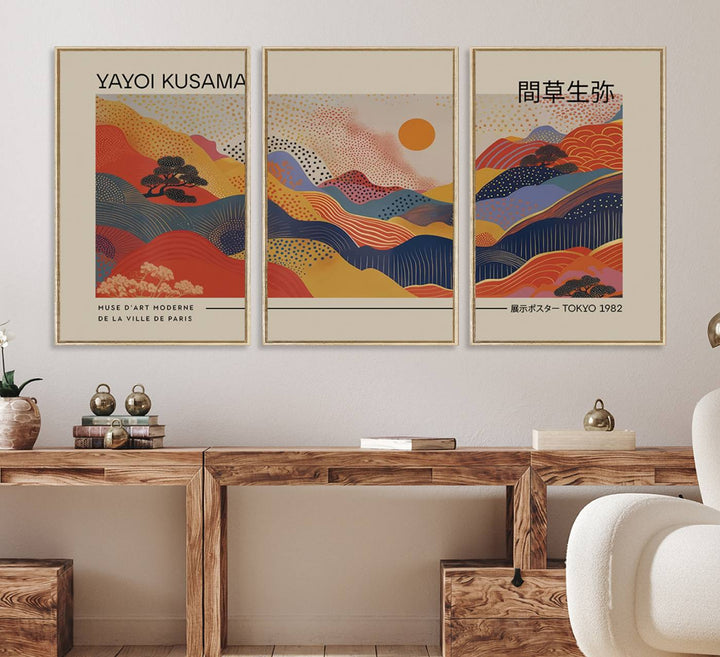 The Yayoi Kusama vibrant landscape canvas print featuring abstract mountains and a sun enhances the space with its modern aesthetic.