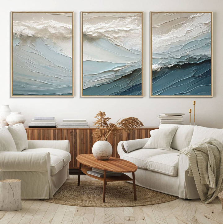 The Waves Abstract Wall Art Print is a large textured painting featuring ocean waves in beige and blue tones. This modern framed abstract canvas print captures the serene essence of seaside tranquility and serves as stunning ready-to-hang wall art, making it perfect as living room decor.