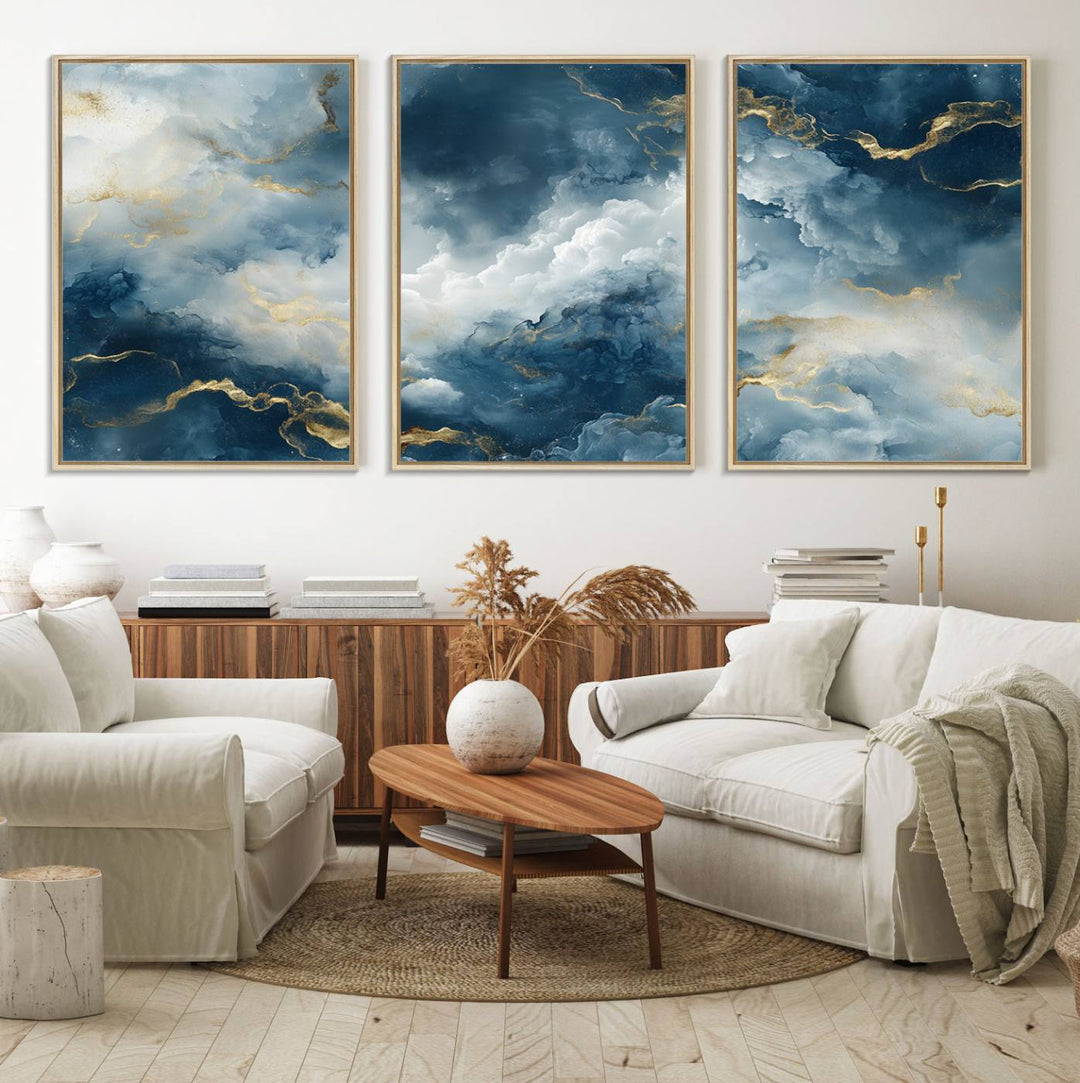 The "Large Abstract Print - Luxe Blue and Gold Abstract Canvas Wall Art" features a bold cloudscape design with swirling white patterns, ideal for modern home decor in living rooms or offices.